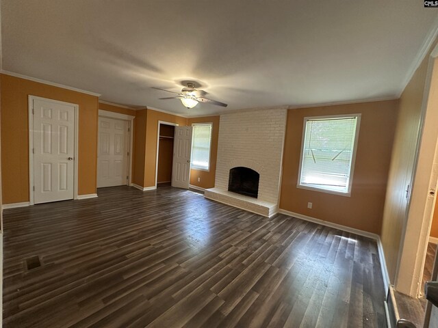 unfurnished living room featuring ceiling fan, baseboards, a fireplace, and ornamental molding