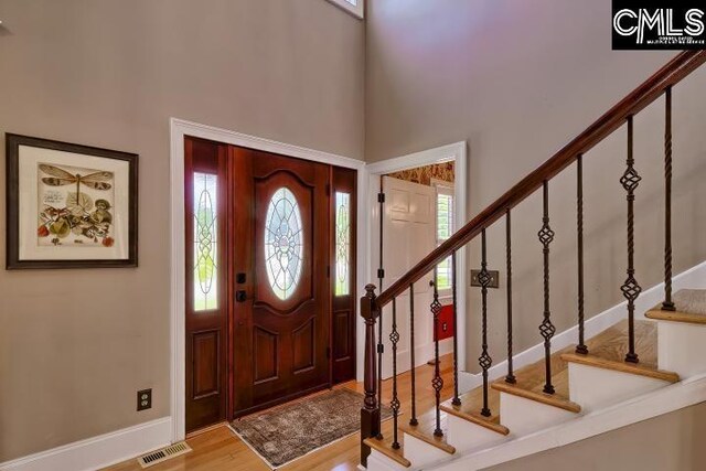 121 Cove View Dr, Irmo, SC 29063 - foyer featuring visible vents, wood finished floors, stairway, and a towering ceiling