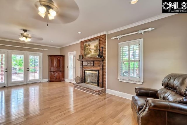 121 Cove View Dr, Irmo, SC 29063 - living area with ceiling fan, crown molding, a brick fireplace, baseboards, and a wealth of natural light