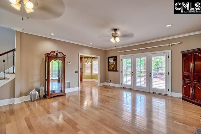 121 Cove View Dr, Irmo, SC 29063 - unfurnished living room with crown molding, baseboards, light wood-style floors, and a ceiling fan