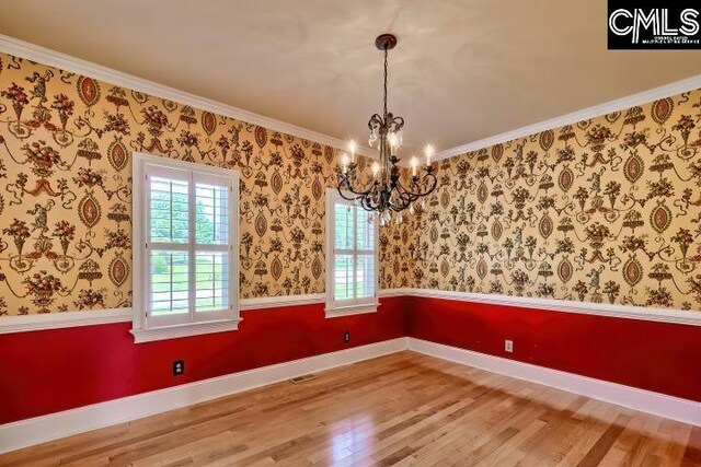 121 Cove View Dr, Irmo, SC 29063 - unfurnished dining area with crown molding, a chandelier, wood finished floors, and visible vents