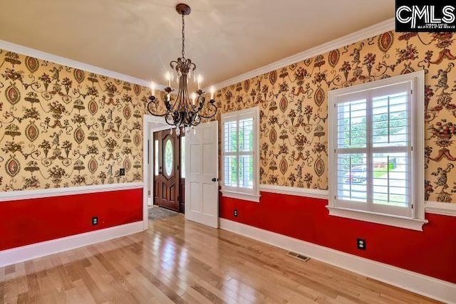 121 Cove View Dr, Irmo, SC 29063 - unfurnished dining area featuring visible vents, wood finished floors, baseboards, a chandelier, and ornamental molding