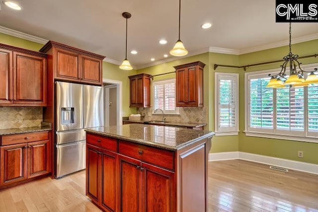 121 Cove View Dr, Irmo, SC 29063 - kitchen featuring crown molding, stainless steel fridge, a sink, light wood finished floors, and a chandelier