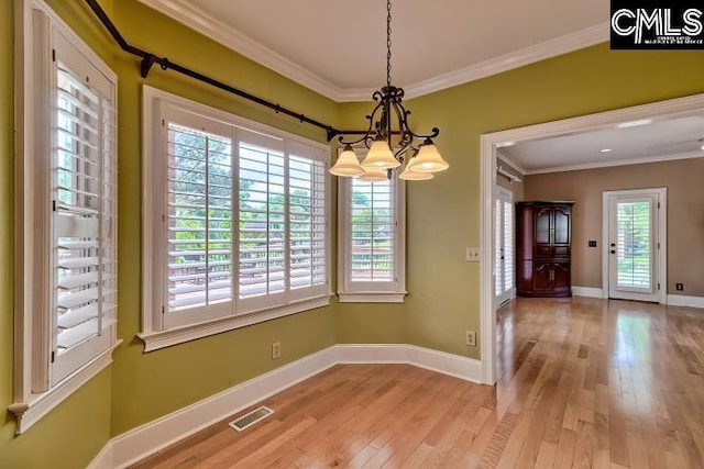 121 Cove View Dr, Irmo, SC 29063 - unfurnished dining area featuring crown molding, light wood-style floors, a notable chandelier, and visible vents