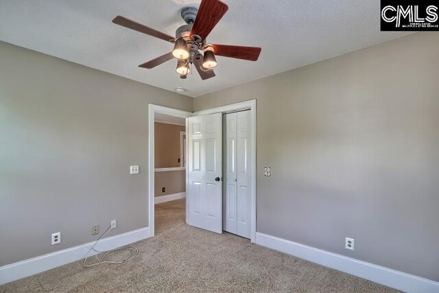 121 Cove View Dr, Irmo, SC 29063 - unfurnished bedroom featuring baseboards, carpet, ceiling fan, and a closet