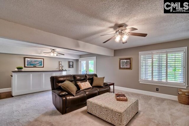 121 Cove View Dr, Irmo, SC 29063 - living area featuring a textured ceiling, ceiling fan, and light colored carpet