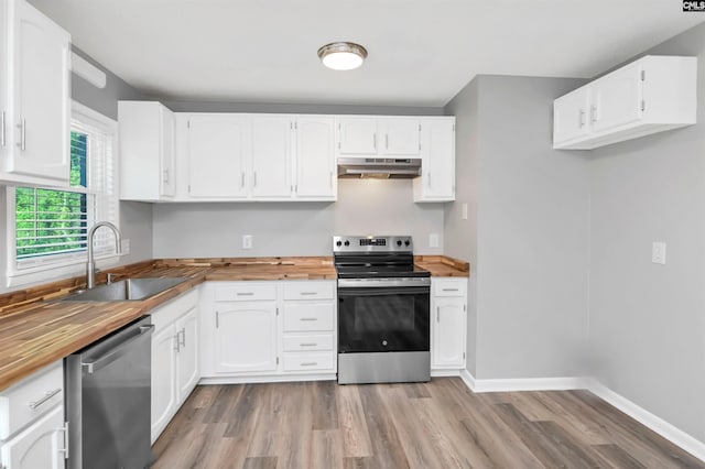 2723 Dubard St, Columbia, SC 29204 - kitchen with butcher block countertops, a sink, under cabinet range hood, and stainless steel appliances