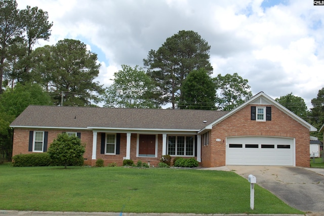view of front of home featuring a shingled roof, an attached garage, a front lawn, brick siding, and driveway