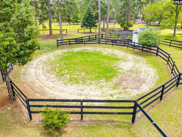view of home's community with a yard, fence, and an outdoor structure