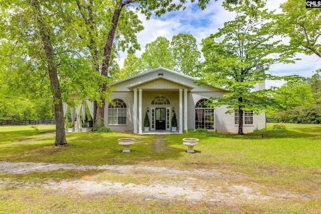 back of house featuring a lawn and fence
