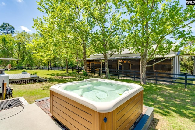 exterior space featuring a hot tub, a deck, and an exterior structure