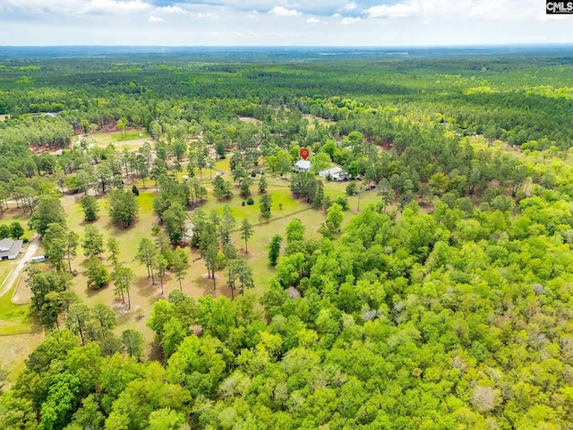 aerial view featuring a wooded view