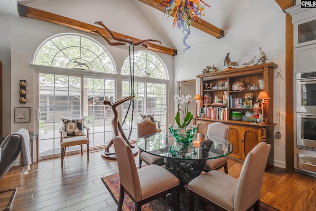 dining area with high vaulted ceiling, a healthy amount of sunlight, beam ceiling, and wood finished floors