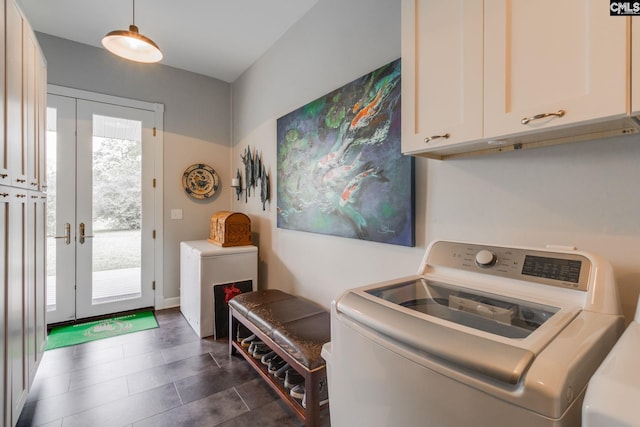 washroom featuring washer / clothes dryer, french doors, and cabinet space