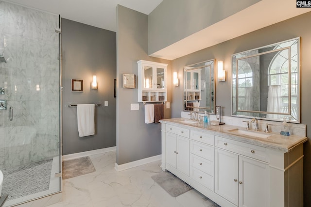 full bath featuring a marble finish shower, marble finish floor, baseboards, and a sink