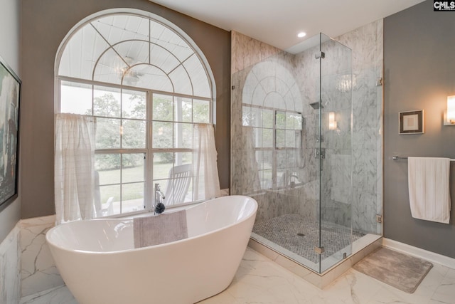 full bath with a stall shower, plenty of natural light, and marble finish floor