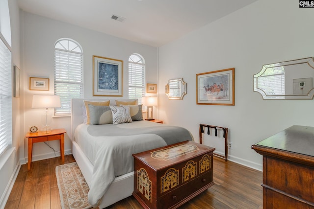 bedroom featuring visible vents, wood finished floors, and baseboards