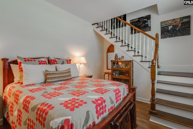bedroom with baseboards and wood finished floors