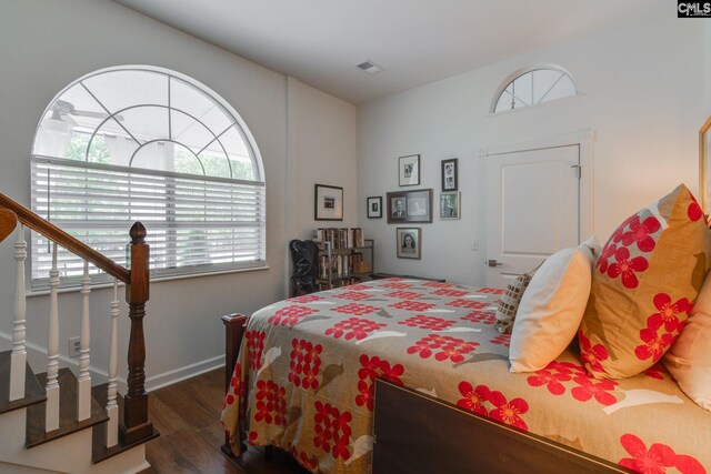 bedroom featuring multiple windows, visible vents, and wood finished floors