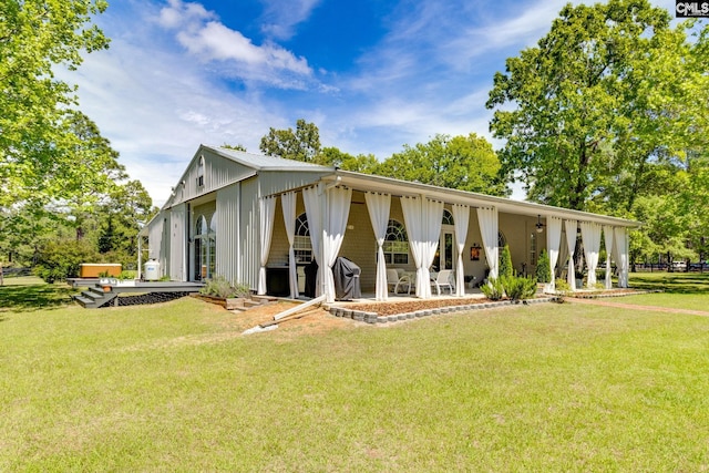 view of front facade with a patio and a front yard
