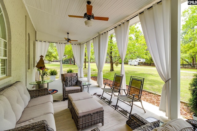 sunroom featuring ceiling fan and outdoor lounge area