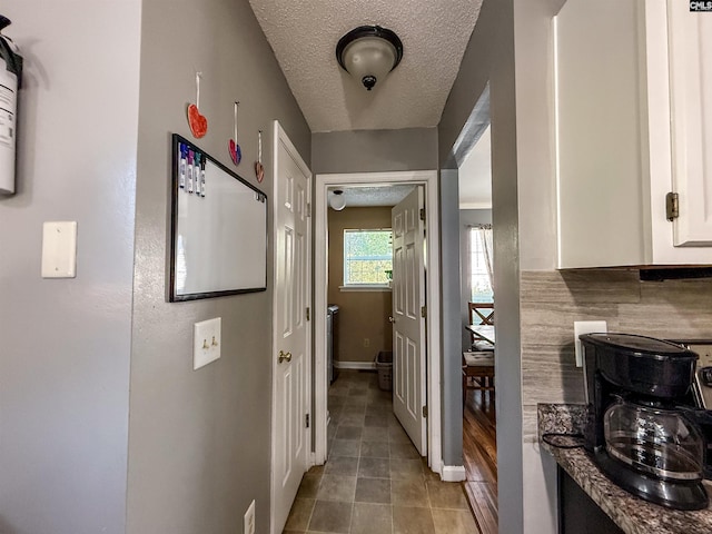 10 Mystic Way Dr, Columbia, SC 29229 - hallway with a textured ceiling, light tile patterned floors, and baseboards
