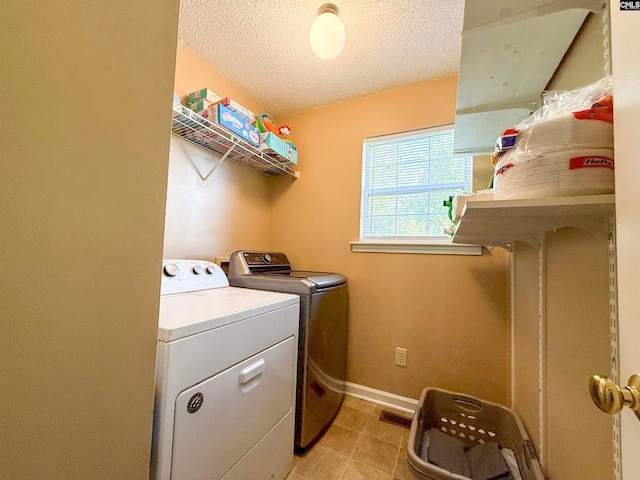10 Mystic Way Dr, Columbia, SC 29229 - laundry area with washer and clothes dryer, a textured ceiling, light tile patterned floors, and baseboards