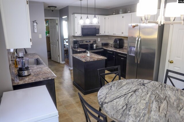 10 Mystic Way Dr, Columbia, SC 29229 - kitchen featuring appliances with stainless steel finishes, a center island, decorative backsplash, white cabinets, and pendant lighting