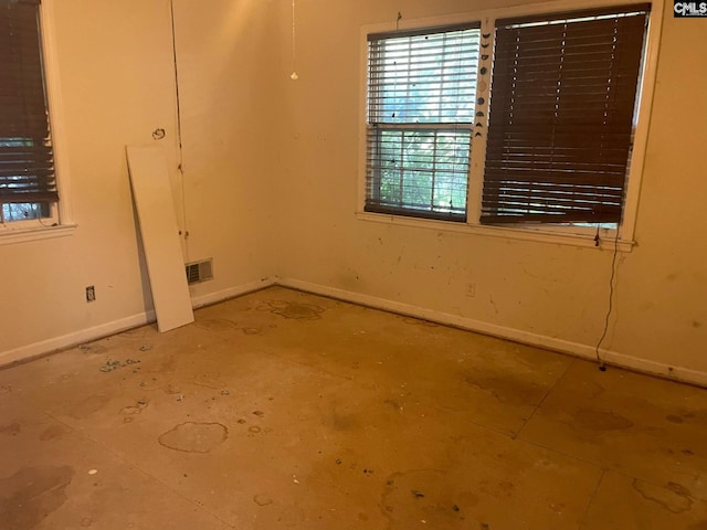 spare room featuring baseboards and visible vents