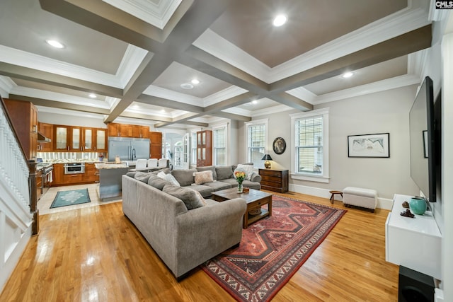 living area featuring crown molding, beamed ceiling, baseboards, light wood-type flooring, and coffered ceiling