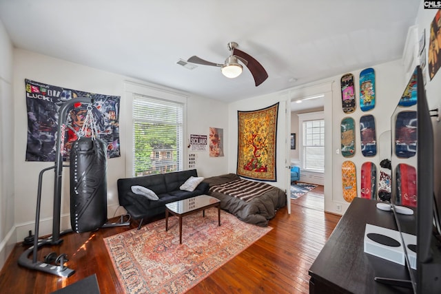 living room featuring ceiling fan, plenty of natural light, and hardwood / wood-style floors