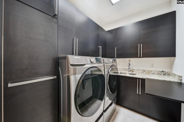 washroom with independent washer and dryer, a sink, and cabinet space