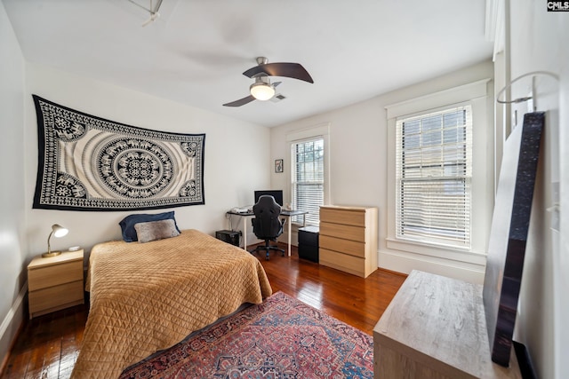 bedroom with baseboards, visible vents, ceiling fan, and dark wood-type flooring