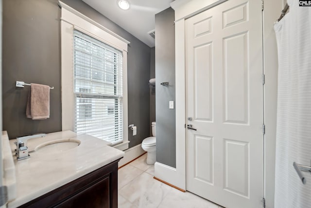 full bath with vanity, baseboards, and toilet