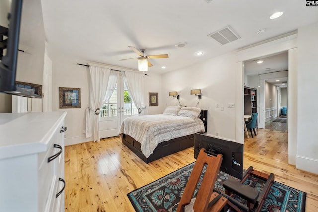 bedroom with light wood-style floors, access to exterior, french doors, and visible vents