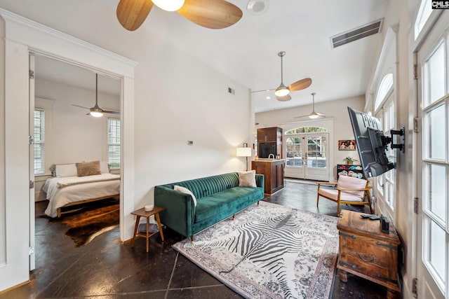 living room featuring visible vents, finished concrete flooring, and ceiling fan