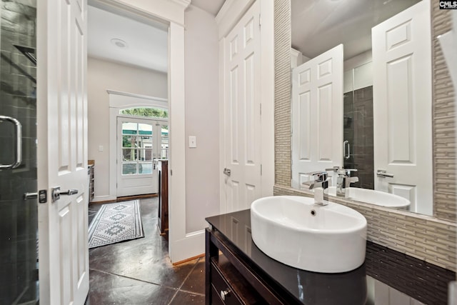 full bathroom with finished concrete flooring, vanity, baseboards, tasteful backsplash, and a stall shower