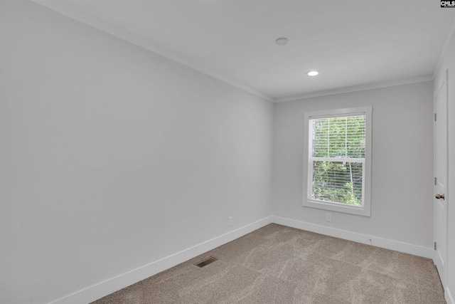 spare room with baseboards, crown molding, visible vents, and light colored carpet