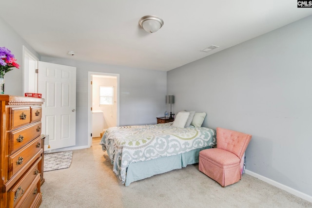 bedroom with ensuite bath, light colored carpet, baseboards, and visible vents