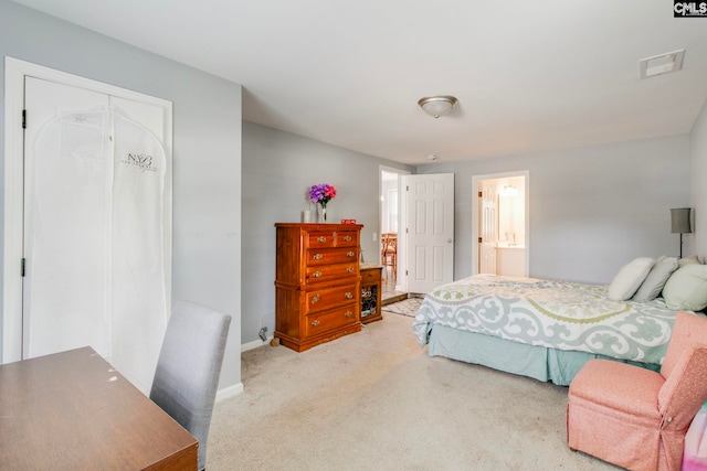 carpeted bedroom featuring baseboards, a closet, and visible vents