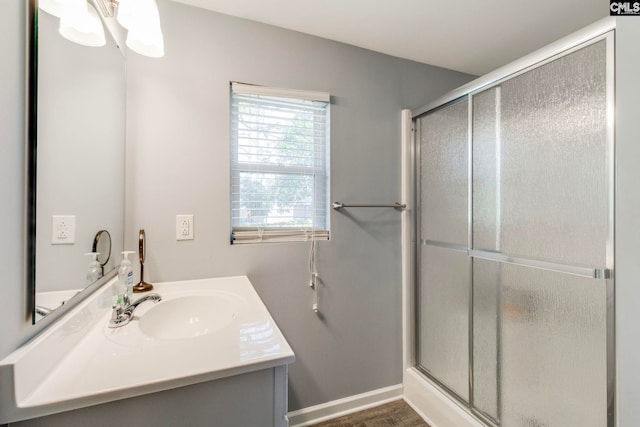 bathroom featuring vanity and a shower stall