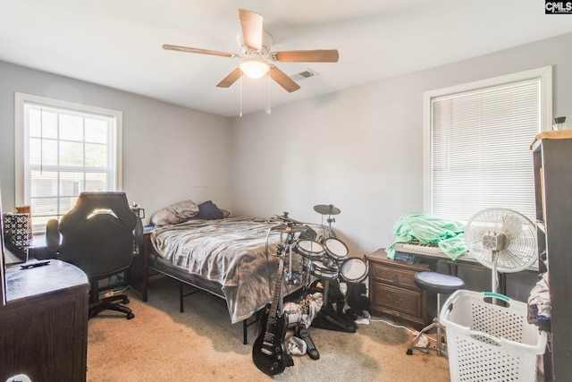 bedroom with visible vents, a ceiling fan, and carpet floors