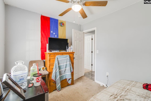 bedroom with light carpet, baseboards, and ceiling fan