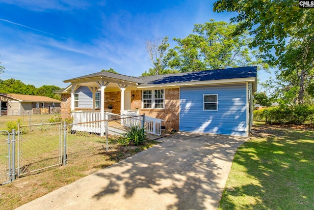 bungalow-style house featuring driveway, a porch, brick siding, and a front lawn