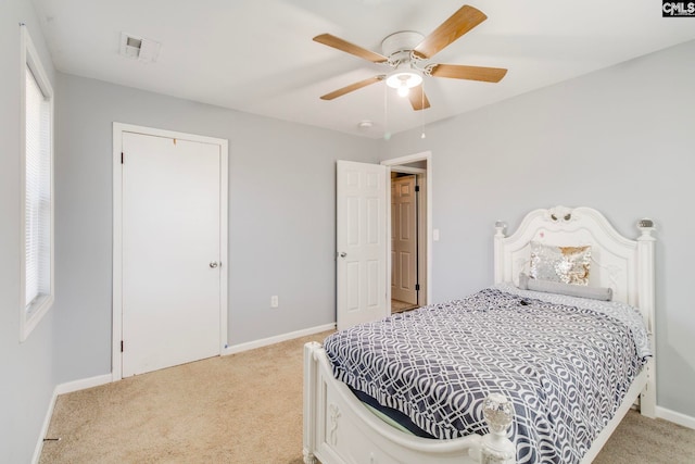 bedroom featuring ceiling fan, light carpet, baseboards, and visible vents