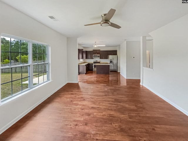 320 Southbrook Dr, Lexington, SC 29073 - unfurnished living room with ceiling fan, baseboards, and wood finished floors