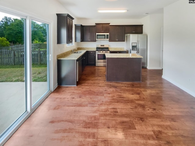 320 Southbrook Dr, Lexington, SC 29073 - kitchen with wood finished floors, a sink, baseboards, appliances with stainless steel finishes, and a kitchen island