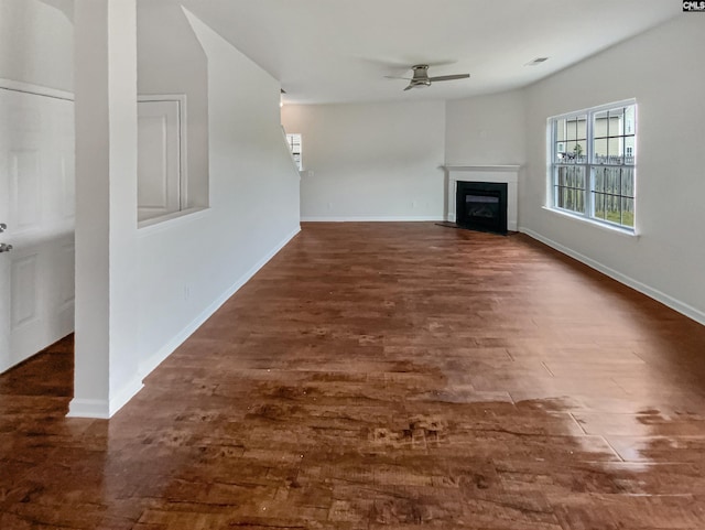 320 Southbrook Dr, Lexington, SC 29073 - unfurnished living room featuring a fireplace with flush hearth, dark wood-style flooring, baseboards, and ceiling fan