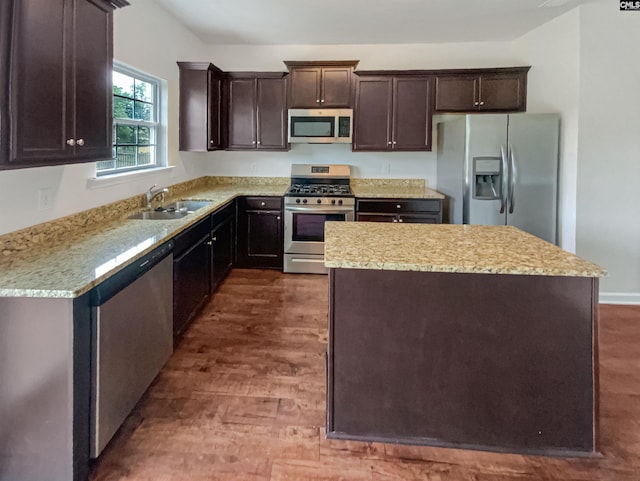 320 Southbrook Dr, Lexington, SC 29073 - kitchen featuring dark brown cabinets, a kitchen island, a sink, dark wood-type flooring, and appliances with stainless steel finishes