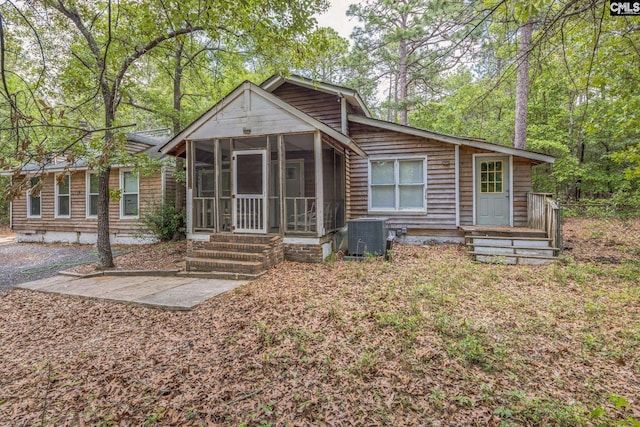 back of house featuring a sunroom and central air condition unit
